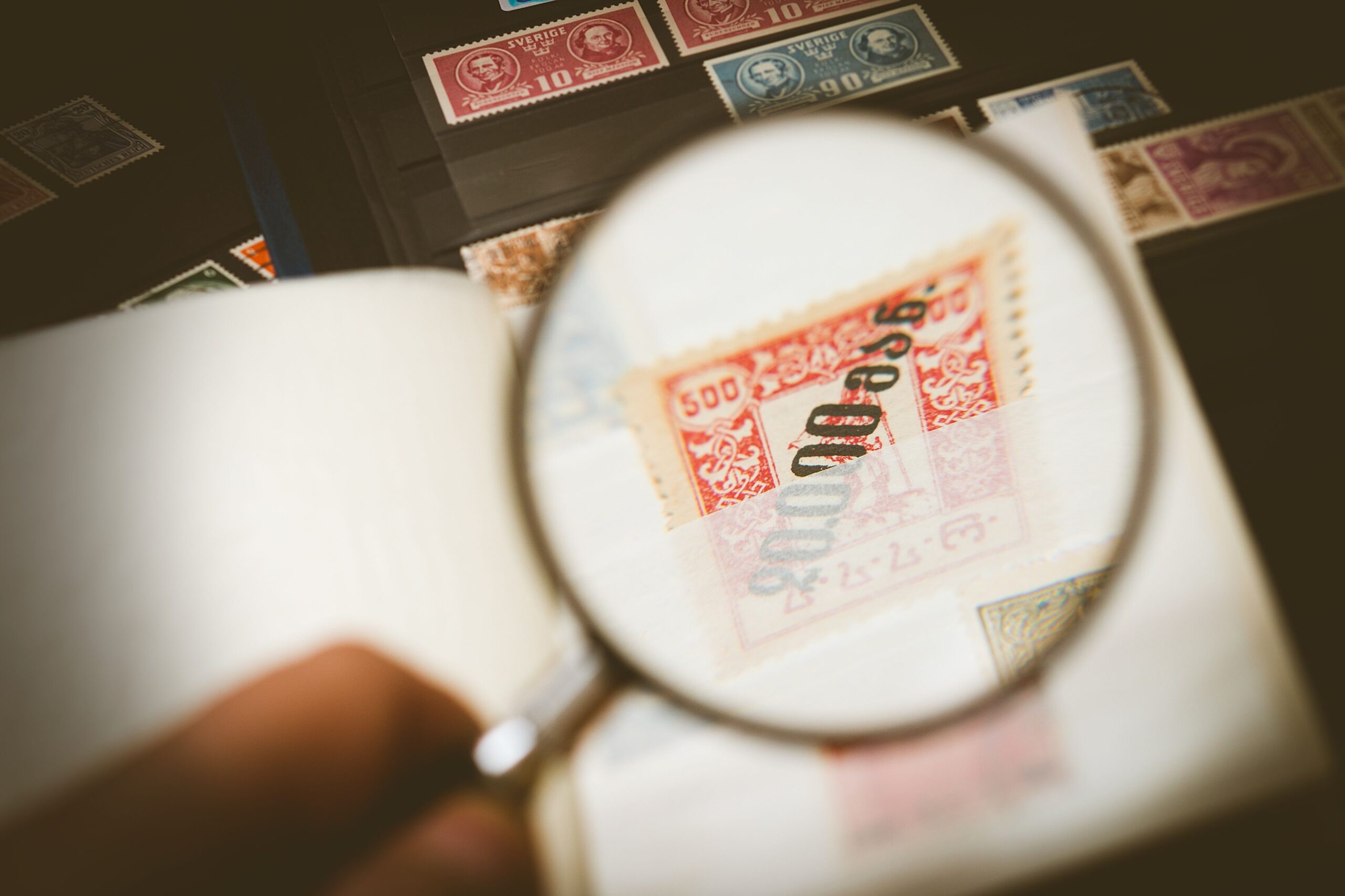 Vintage stamps viewed under magnification for researching sold prices