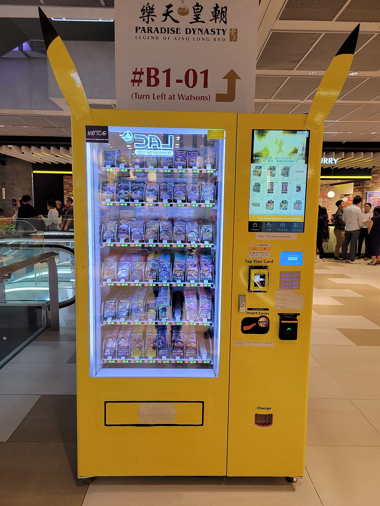 Trading card vending machine with various collectible card packs on display