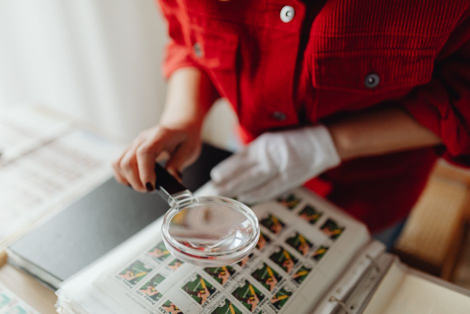 Person examining items with a magnifying glass