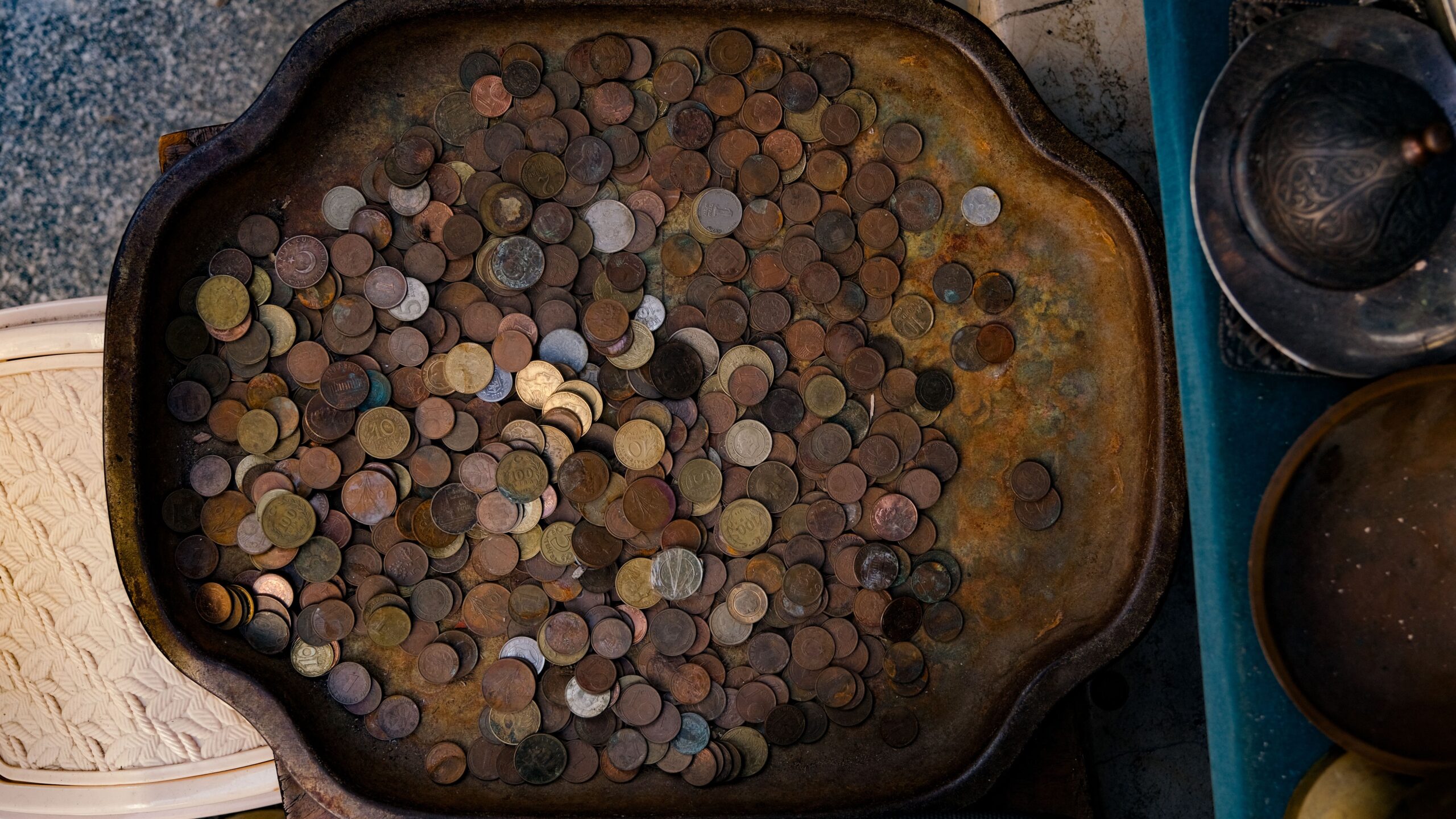 Vintage coins arranged on a tray for a provenance guide