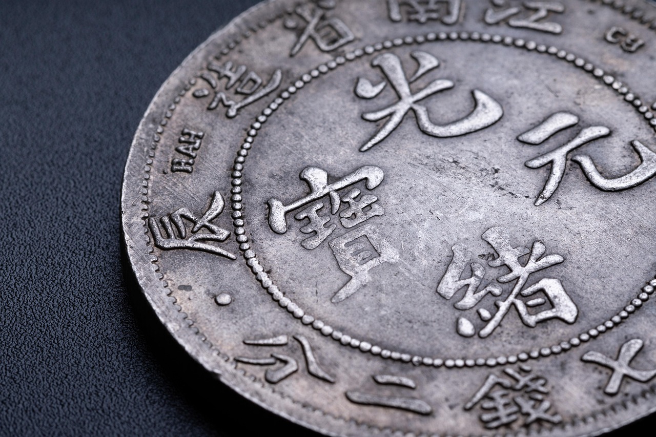 How to Read a Coin Price Guide Without Falling for Inflated Retail Numbers 2 Coins and coin collecting tools on display