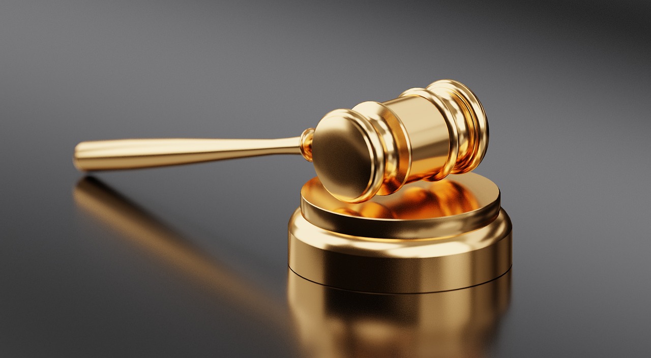 How to Read a Coin Auction Listing Without Confusing Estimate, Reserve, and Sold Price 2 auctioneer at podium with gavel and bidding paddle visible