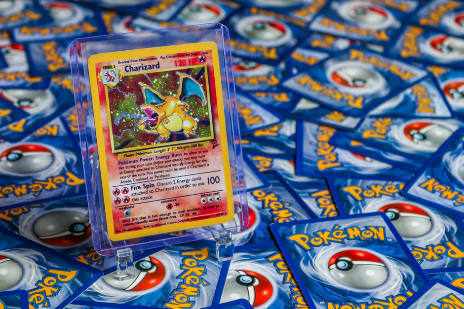 How to Build a Pokémon Card Binder Around One Set Without Buying Duplicates 2 High-value Charizard Pokémon trading card surrounded by various other cards