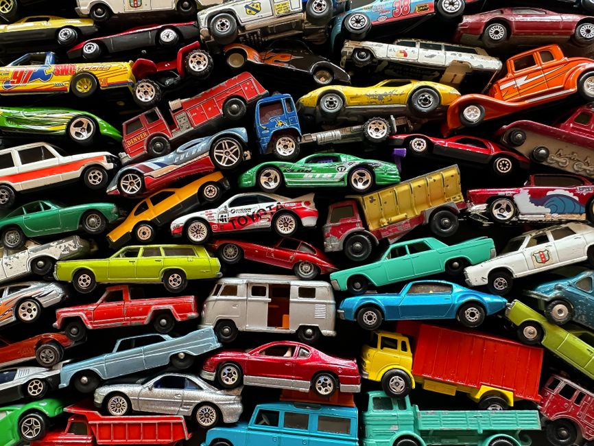 Colorful assortment of miniature diecast toy cars arranged together