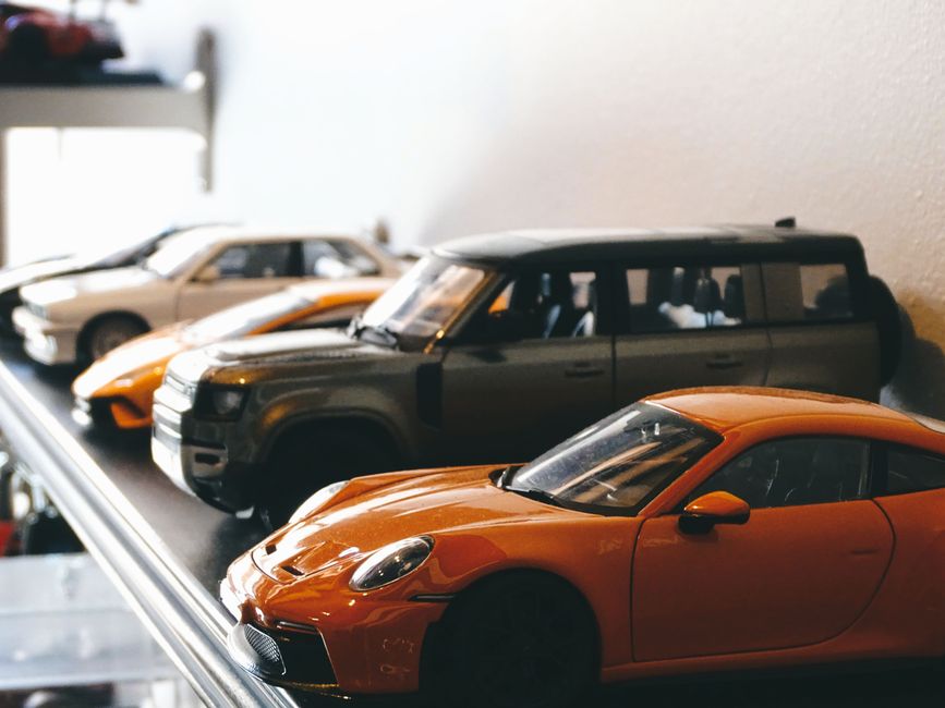 Model cars displayed on a shelf showing classic automotive design