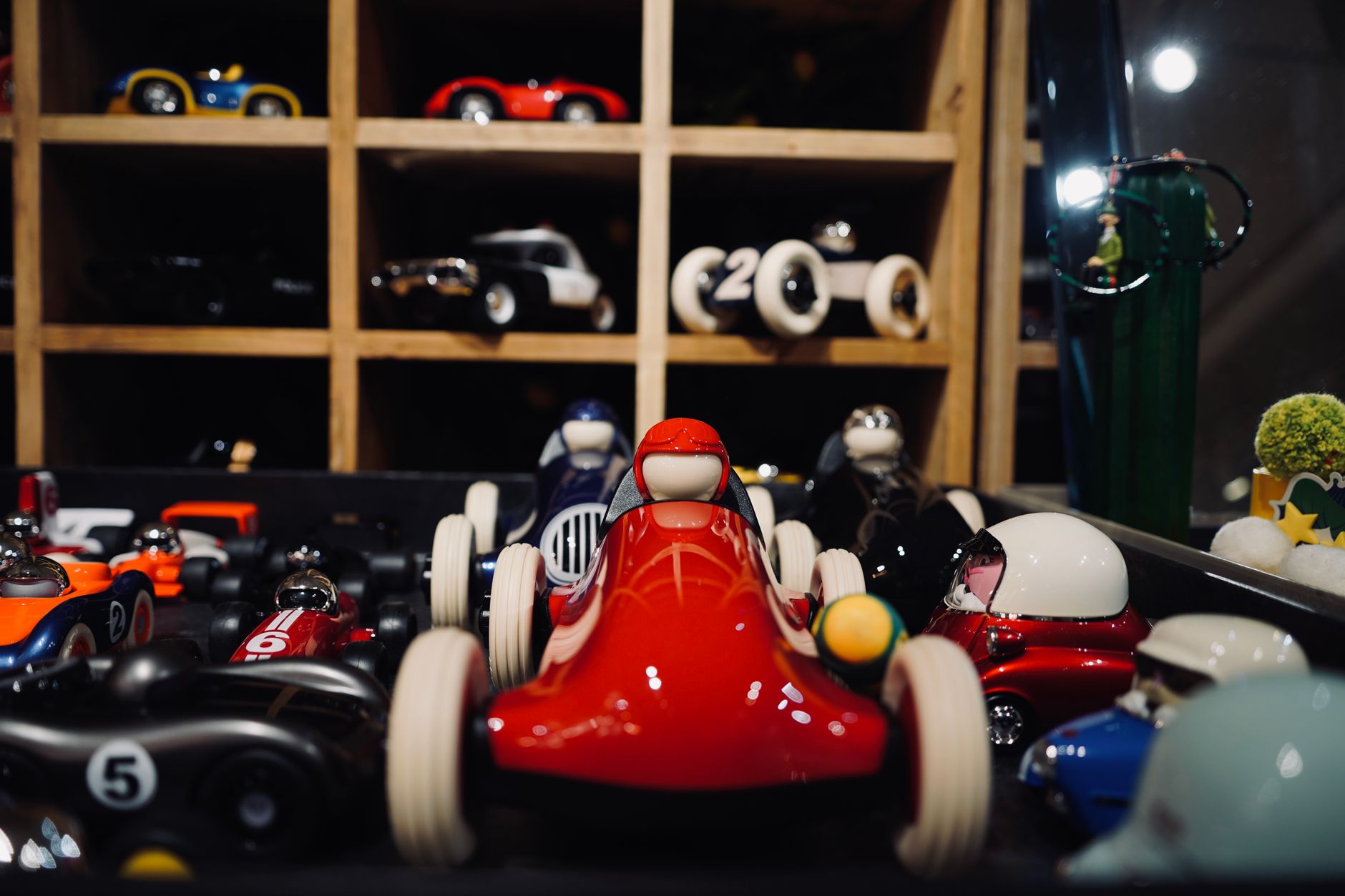 Miniature diecast model cars displayed in a wooden case