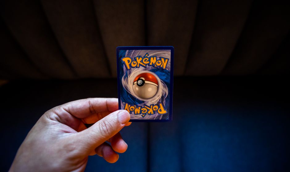 Close-up of a person holding and inspecting a collectible trading card