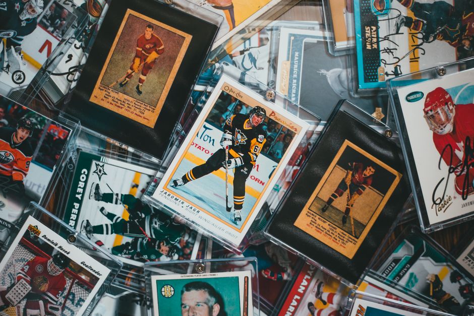Vintage and modern hockey trading cards spread out for inspection